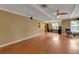 Open living room with hardwood floors, ceiling fan, and a view into the adjacent rooms at 605 15Th Avenue E Dr, Palmetto, FL 34221