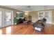 Living room featuring hardwood floors, a comfortable leather couch, and access to the outdoors at 605 15Th Avenue E Dr, Palmetto, FL 34221