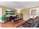 Spacious living room with hardwood floors, a large television, and plenty of natural light at 605 15Th Avenue E Dr, Palmetto, FL 34221
