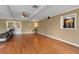 Spacious living room featuring hardwood floors, ceiling fan, and double doors at 605 15Th Avenue E Dr, Palmetto, FL 34221