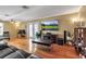Cozy living room with hardwood floors, comfortable seating, and a large screen television at 605 15Th Avenue E Dr, Palmetto, FL 34221
