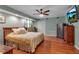 Spacious main bedroom featuring hardwood floors, ample lighting, soft colors, and ceiling fan at 605 15Th Avenue E Dr, Palmetto, FL 34221