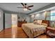 Spacious main bedroom featuring hardwood floors, ample lighting, soft colors, and ceiling fan at 605 15Th Avenue E Dr, Palmetto, FL 34221