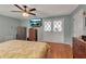 Spacious main bedroom featuring hardwood floors, ample lighting, soft colors, and ceiling fan at 605 15Th Avenue E Dr, Palmetto, FL 34221