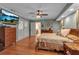 Spacious main bedroom featuring hardwood floors, ample lighting, soft colors, and ceiling fan at 605 15Th Avenue E Dr, Palmetto, FL 34221