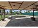 Covered patio overlooking a fenced-in backyard with a swimming pool and landscaping at 605 15Th Avenue E Dr, Palmetto, FL 34221