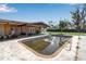 Back exterior view showing the in-ground pool and covered patio at 605 15Th Avenue E Dr, Palmetto, FL 34221