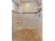 Tiled shower features a glass door, built-in bench, shelving, and a modern shower head at 605 15Th Avenue E Dr, Palmetto, FL 34221