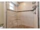 Elegant tiled shower features a glass door, built-in bench, and convenient shelving at 605 15Th Avenue E Dr, Palmetto, FL 34221