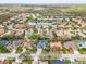Aerial view of home with screened pool in a lush community near a lake at 6215 Aventura Dr, Sarasota, FL 34241