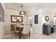 Well-lit dining area with seating for six, updated lighting, stylish decor, and neutral paint at 6215 Aventura Dr, Sarasota, FL 34241
