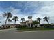 Stately clubhouse with white pillars and manicured landscaping, set against a blue sky with scattered clouds at 7016 Brier Creek Ct, Lakewood Ranch, FL 34202