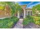 Inviting front entrance with double doors, stately pillars, and lush, verdant landscaping at 7016 Brier Creek Ct, Lakewood Ranch, FL 34202