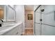 Contemporary bathroom with white cabinets, a marble countertop, and a walk-in shower at 7347 Royal Birkdale Dr, Sarasota, FL 34238