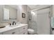 This bathroom features a modern vanity with a marble countertop and tiled walk-in shower at 7347 Royal Birkdale Dr, Sarasota, FL 34238