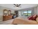 Comfortable bedroom with a king-size bed, sliding glass doors to the lanai, and views of the canal at 7347 Royal Birkdale Dr, Sarasota, FL 34238