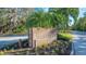 BALLANTRAE sign sitting amongst lush landscape near the entrance to the private community at 7347 Royal Birkdale Dr, Sarasota, FL 34238