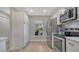 Well-equipped kitchen with stainless steel appliances, white cabinets, and ample counter space, perfect for culinary enthusiasts at 7347 Royal Birkdale Dr, Sarasota, FL 34238