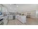 Spacious kitchen with white cabinets, stainless steel appliances, and an island with a wine cooler for added convenience at 7347 Royal Birkdale Dr, Sarasota, FL 34238