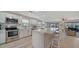 Modern kitchen featuring stainless steel appliances, a marble countertop island, and an adjacent living area for seamless entertaining at 7347 Royal Birkdale Dr, Sarasota, FL 34238