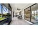 The screened lanai features water views, tiled floors, comfortable seating, and seamless indoor-outdoor living at 7347 Royal Birkdale Dr, Sarasota, FL 34238