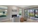 The living room features a modern fireplace, comfortable chairs, and a view of the screened lanai at 7347 Royal Birkdale Dr, Sarasota, FL 34238