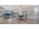 Open living room featuring a dining table, ample seating, and bright, natural light at 7347 Royal Birkdale Dr, Sarasota, FL 34238