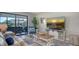 Living room boasts a cozy seating area and an entertainment unit with a beach sunset view at 7347 Royal Birkdale Dr, Sarasota, FL 34238