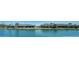 Panoramic water view showing manicured lawns and residences from across the lake at 7347 Royal Birkdale Dr, Sarasota, FL 34238
