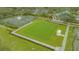 Aerial image of tennis and pickleball courts, croquet court, clubhouse, and other recreational spaces at 7432 Ascot Ct, University Park, FL 34201