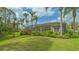 Well-manicured backyard with lush green lawn and mature landscaping, perfect for outdoor activities and relaxation at 7432 Ascot Ct, University Park, FL 34201