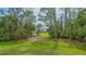 Lush backyard with mature trees offering privacy and natural beauty at 7432 Ascot Ct, University Park, FL 34201