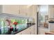 Modern kitchen featuring light cabinets, black countertops, stylish decor and backsplash at 7432 Ascot Ct, University Park, FL 34201