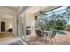Covered lanai with a ceiling fan, outdoor grill, and table adjacent to the pool, perfect for entertaining and relaxation at 7432 Ascot Ct, University Park, FL 34201