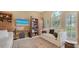 Comfortable living room with large windows, TV, built-in shelving, and ample seating at 7432 Ascot Ct, University Park, FL 34201