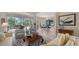 Bright living room offers views of the lanai, pool, and golf course, creating a relaxing indoor-outdoor living space at 7432 Ascot Ct, University Park, FL 34201