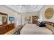 Spacious main bedroom with tray ceilings, hardwood floors, TV and private ensuite at 7432 Ascot Ct, University Park, FL 34201