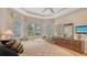 Cozy main bedroom featuring tray ceilings, plantation shutters, and ample natural light at 7432 Ascot Ct, University Park, FL 34201