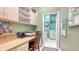 Dedicated office space with custom built-ins, desk area, and adjacent laundry room at 7432 Ascot Ct, University Park, FL 34201