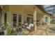 Relaxing outdoor patio with ample seating, a built-in kitchen, and a pool view at 7432 Ascot Ct, University Park, FL 34201