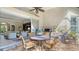 Inviting outdoor patio area with comfortable seating, a grill, and seamless transition to indoor living space at 7432 Ascot Ct, University Park, FL 34201