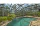 Relaxing screened pool area with lush landscaping and a serene atmosphere, ideal for enjoying the outdoors at 7432 Ascot Ct, University Park, FL 34201