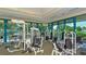 Well-equipped weight room with machines and ample space, features blue-framed windows and good light at 7432 Ascot Ct, University Park, FL 34201