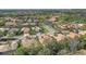 Aerial shot showcases homes surrounded by trees, ponds, and well-kept lawns at 7762 Us Open Loop, Lakewood Ranch, FL 34202