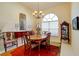 Formal dining room showcasing elegant furnishings, chandelier, and ample natural light at 7762 Us Open Loop, Lakewood Ranch, FL 34202