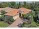 Beautiful single-story home featuring a well-manicured lawn, mature trees, and a brick driveway at 7762 Us Open Loop, Lakewood Ranch, FL 34202