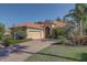 Charming home featuring a brick driveway, tile roof, and lush landscaping at 7762 Us Open Loop, Lakewood Ranch, FL 34202