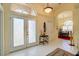 Bright foyer with decorative glass doors and views into the dining room at 7762 Us Open Loop, Lakewood Ranch, FL 34202