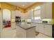Bright eat-in kitchen featuring white cabinetry, stainless steel appliances, and granite countertops at 7762 Us Open Loop, Lakewood Ranch, FL 34202