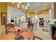 Bright eat-in kitchen with white cabinets, tile floor, pendant lights, and stainless steel appliances at 7762 Us Open Loop, Lakewood Ranch, FL 34202
